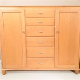 Ethan Allen Maple Chest of Drawers: An Ethan Allen chest of drawers in maple. The unit has a door on each side revealing three shelves and six drawers down the middle.. Two of the shelves on each side are adjustable. The modern design features straight lines with nickel hardware on the door and sits on four short tapered legs.