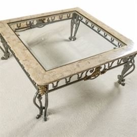 Marble and Glass Top Coffee Table: A metal frame coffee table with marble, brass and beveled glass top. The top has an outer 5" wide frame of stone, assembled from rectangular tiles and rounded at the outer edge and corner, with a brass fillet on the inside holding a central square piece of beveled glass. The base has bent and cut metal serpantine legs with a arching metal design in the apron all with a drab green finish. Both the legs and apron have floral embelishments in a bronze tone.