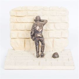 Sam Philipe Silver Plate Sculpture "Soldier at the Wall": A silver plate sculpture by Sam Philipe ( Israeli, 20th century) titled Soldier at the Wall. This sculpture depicts a uniformed and armed Israeli soldier leaning against the Wailing Wall, his head resting on his raised arm, his helmet cast to the ground at his side. The soldier is crafted from formed electroplated silver and the wall is made of stone. The sculpture is signed by hand “Sam Philipe,” along with the edition number “5/7.”