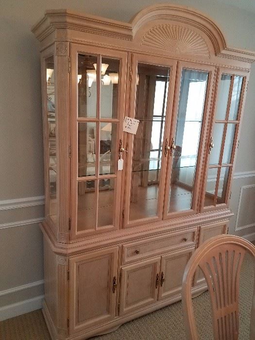 Solid bleached wood lighted china cabinet.