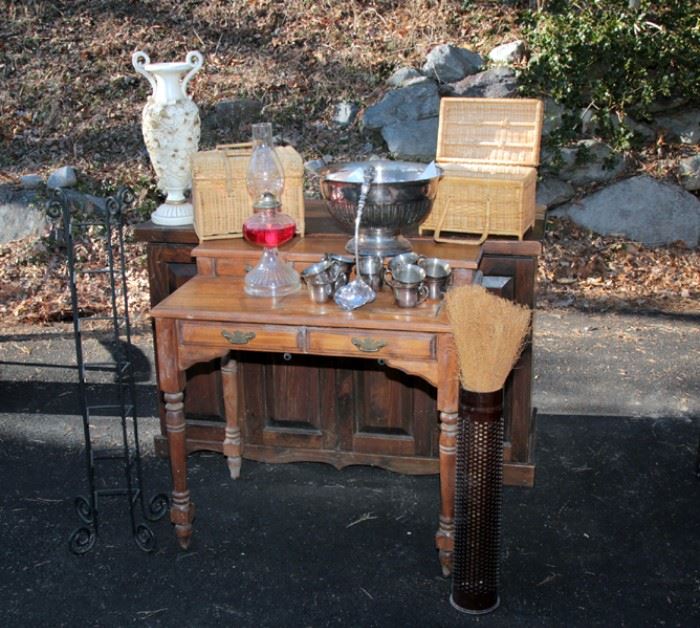 metal plant stands, oil lamps, silver plated punch bowl, wicker picnic baskets, ornamental vases, secretary desk