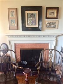 Group of paintings by Simone over a classic fireside hearth