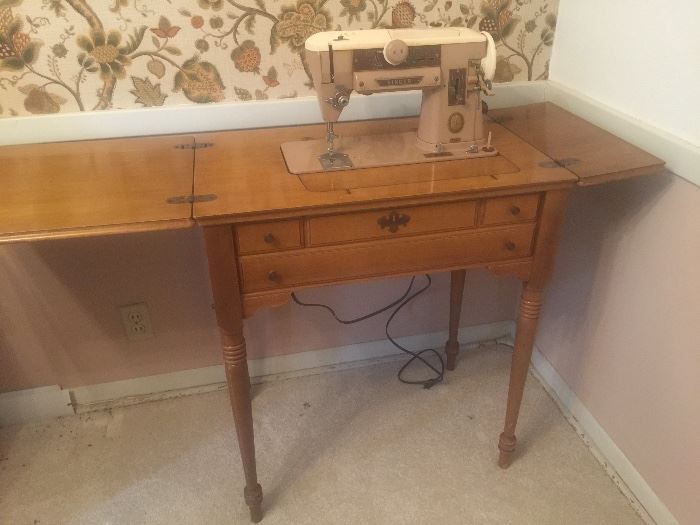 Singer sewing machine in maple cabinet