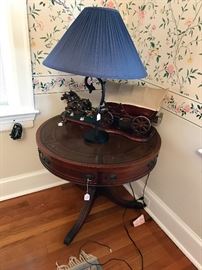 Antique round mahogany table and wagon lamp on top 