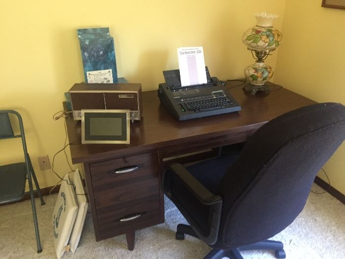 Office desk, office chair(SOLD), type writer(SOLD), vintage hurricane lamp, vintage 'Geneva Vikings' stadium cushions(SOLD), and more.