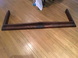 Arts and craft hammered copper over wood fireplace fender.