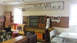 Antique Saratoga racetrack Sale and Exchange Stable sign, many antique and antique style woodworking chests and cabinets with multiple small drawers