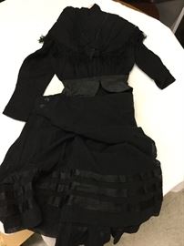 Dress # 67.  1900s black crepe Victorian dress with fringe and beading.  collar fraying, hole on back of jacket, silk trim torn on jacket, skirt torn at back opening and other small tears.  bust 34", shoulder 28", waist 22"