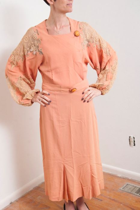 Dress #50.  tag reads "Adaption  Agnes, 6 Rue S'Florentin, Paris.  Peach/pink crepe de chine with cream lace inserts.  bakelite buttons on collar and belt.  Small lace tear at left shoulder.. bust 32", shoulder indeterminant with lace ,  waist 30"