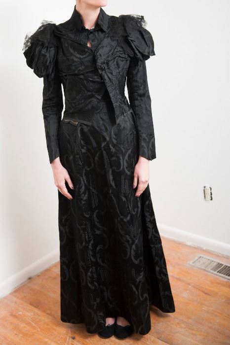 Dress #14.  Satin brocade fabric, black Victorian dress with lace collar trim.  Fraying on waistband of skirt.  bust 28", shoulder 24", waist 24"