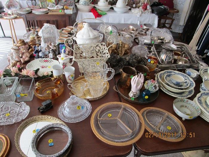 Tables full of accessories, silver, glassware.