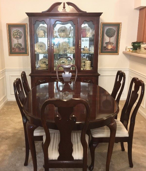 Thomasville oval dining table with six upholstered chairs and two leaves (shown without leaves) and matching china cabinet