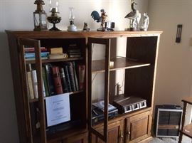 Oak entertainment center.  Measurements:  64"x W x 57"H x 23"D.  3 shelves behind 2 hinged glass doors.