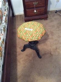 Vintage piano stool with cast iron legs. 