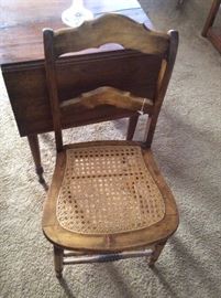 We have a pair of antique cane seat ladder slat back chairs