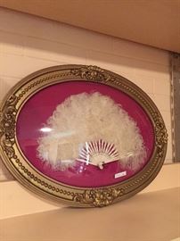 Feathered fan in gold oval frame