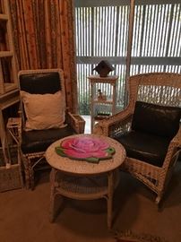 Two of the 3 white wicker chairs; round white wicker side/tea table
