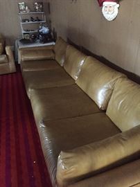 Extra long leather sofa has a companion three-cushioned sofa 