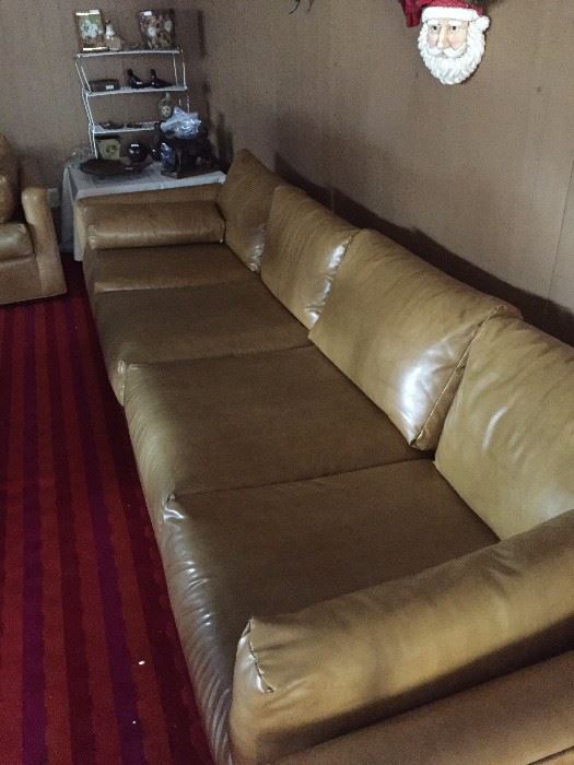 Extra long leather sofa has a companion three-cushioned sofa 