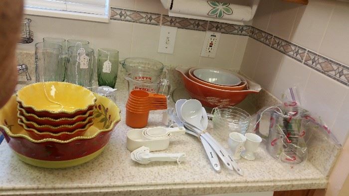 Vintage Pyrex bowls, salad bowl set, measuring cups and spoons, a flour sifter and more in this kitchen.  All very nice items.