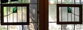 Two of three matching stained glass windows