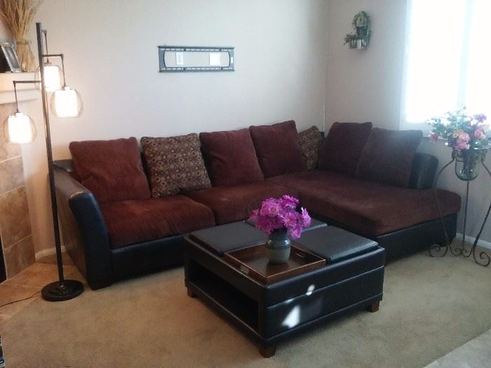 L shaped leather sofa with leather/wood/hardwood ottoman. 