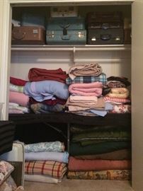 More linens - dozens of vintage luggage