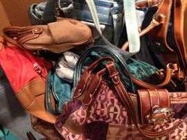 A load of modern handbags many with tags still on!