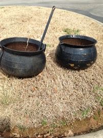 Large antique cast-iron cooking pots, and a Lodge number 12 Dutch oven, not pictured