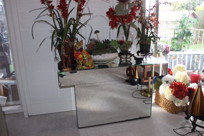 Mirrored sofa table and silk arrangements.