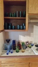 Sets of multicolored wine and beverage glasses, plus three hard-to-find light blue vintage Coca Cola glasses. Also shown, sets of green glasses for everyday use.