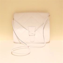 Salvatore Ferragamo Handbag: A Salvatore Ferragamo handbag. The cream leather envelope bag features chevron quilting, a thin shoulder strap and gold tone hardware. There is a handwritten code to the verso of the brand tab which reads, “21-408g.” Made in Italy.