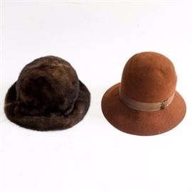 Vintage Mink and Patricia Underwood Felt Cloche Hats: A vintgage mink hat and felt cloche by Patricia Underwood. The two cloche style hats include a mink hat a warm brown tonal hues that has mink that continues to the underside of the brim and a fabric lining. The camel colored felt cloche has a brim band of a woven taupe ribbon and ribbon label to the interior band.