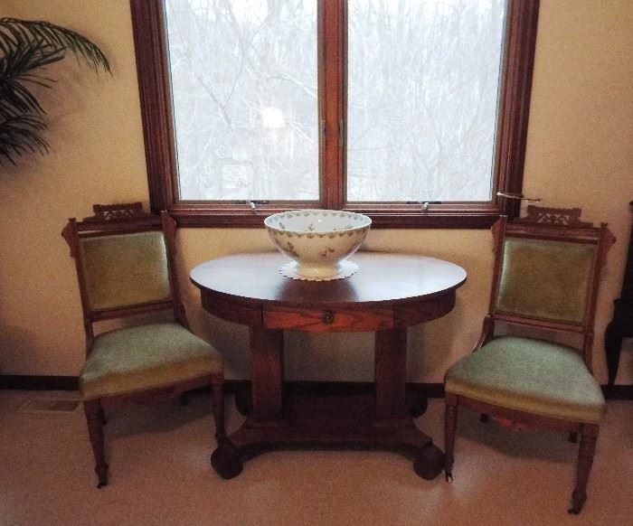 Antique oval library table and pair of Eastlake chairs