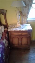 One of a pair marble top side tables