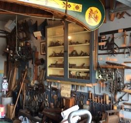 Tools and from the ceiling a "Old Town" wood canoe