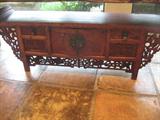 heavily carved table with storage