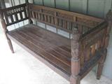 heavily carved wooden bench