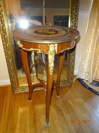 Hand-crafted antique round wooden side table with three legs and golden trims