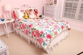 Double bed with iron headboard, painted white.