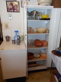 small cabinet, Pyrex dishes, German Roemertopf, etc.