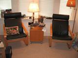 Pair of Maple armed Chairs with Black Leather Cushions and a center Table with glass top.