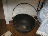 A very old iron handled pot