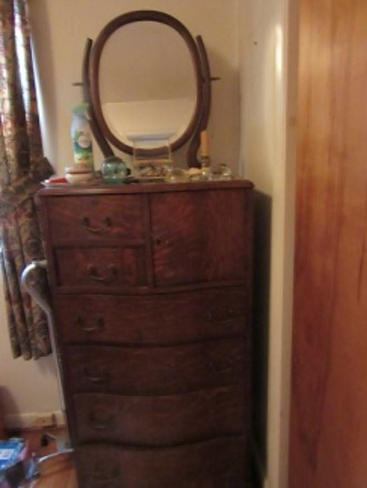 High oak chest with mirror.  The unique drawer arrangement includes a small cupboard.  