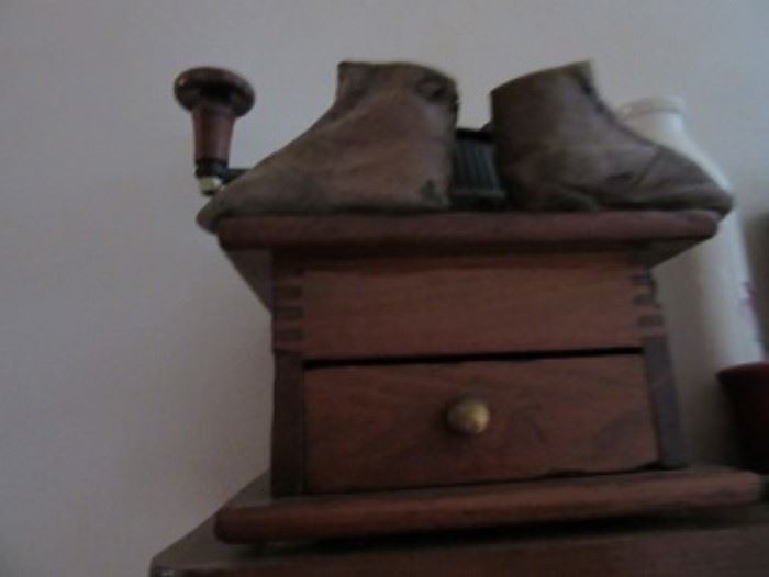 Early coffee mill with early child shoes. 