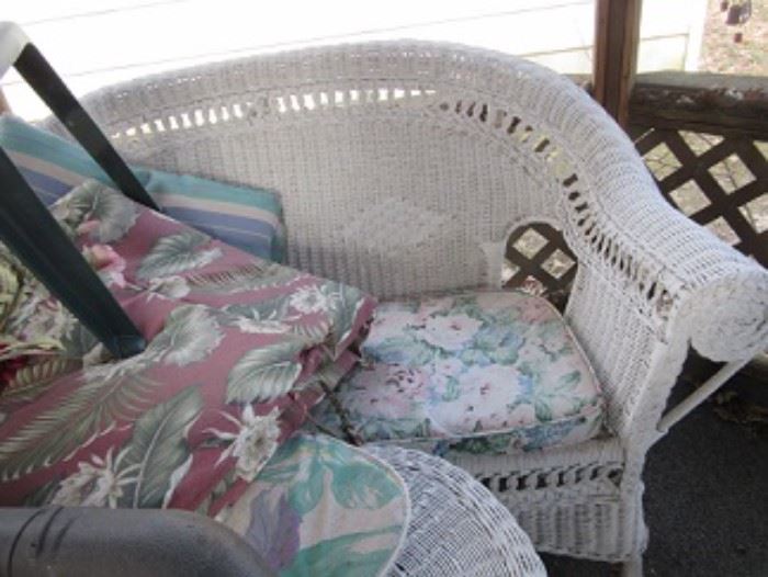 Wicker settee pictured also has a matching wicker rocker.  There are also plastic stacking chairs.  