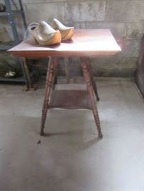 Oak table with lower shelf. The wooden shoes on the top are from Holland. 