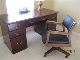 Kneehole desk and an accompanying swivel chair