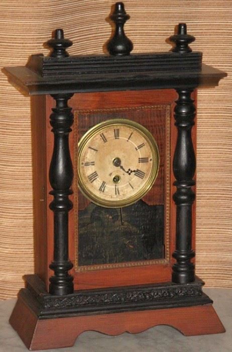 Antique Mantle Clock with black trim and finials, Key Wound Eagle on back panel. No other identifying marks.  (18.5"H x 11"W x 5"D)