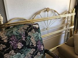 king sized brass bed frame,  behind that king -iron bed headboard 